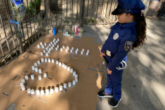 Maria Michelle, 5 stares down at the candles laid out during memorial Candlelight Vigil for NYPD Slain Officer Adrianna Reyes-Gomez. Bronx residents, NYPD officials and Bronx elected officials hold a Candlelight Vigil in honor and in memory of NYPD Transit Officer Adrianna Reyes-Gomez who was brutally murdered in her Bronx apartment at 780 Grand Concourse, Bronx, New York 10451 on Wednesday, June 15, 2022

Photography by Enid B. Alvarez