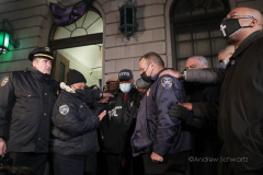 Members of the clergy lay hands on New York City Mayor Eric Adams to bless him outside the 32nd Precinct during a candlelight vigil for two officers that were shot in New York City on January 22, 2022. (Photo by Andrew Schwartz)