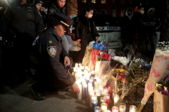 Hundreds of police officers, FDNY officers and members of the public are gathered outside the 32nd Precinct during a candlelight vigil for two officers that were shot in New York City on January 22, 2022. (Photo by Andrew Schwartz)