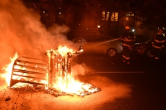 Firefighters put out a fire set by protestors