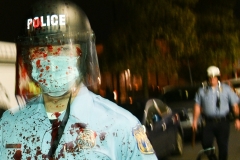 A Philadelphia Police Officer is covered in blood after an altercation during a protest.. (Photo by Lloyd Mitchell)