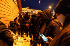 Refugees use their phones at a charging hub after crossing the border from Ukraine into Medyka on March 1, 2022 in Poland. Poland has so far received close to 300,000 refugees since Russia invaded Ukraine on February 24