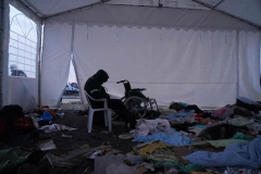A man sits in a tent after making the crossing as refugees cross the border from Ukraine into Medyka on March 1, 2022 in Poland. Poland has so far received close to 300,000 refugees since Russia invaded Ukraine on February 24.