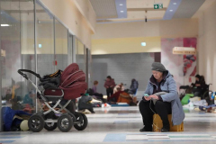Refugees at a temporary transfer point at an abandoned shopping center in Przemysl after crossing the bkrder from Ukraine on March 2, 2022