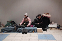 Refugees at a temporary transfer point at an abandoned shopping center in Przemysl after crossing the bkrder from Ukraine on March 2, 2022.