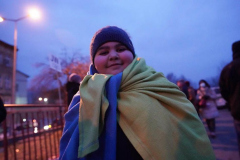 A child smiles after making a 32 hour train ride from Kyiv to Przemysl station after crossing the border from Ukraine on March 2, 2022