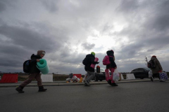 Refugees walk across the border from Ukraine on March 2, 2022 in Medyka, Poland. Poland has received nearly 300,000 refugees from Ukraine since Russia invaded on February 24