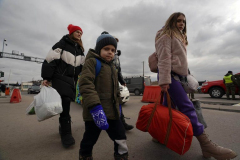 Refugees walk across the border from Ukraine on March 2, 2022 in Medyka, Poland. Poland has received nearly 300,000 refugees from Ukraine since Russia invaded on February 24
