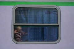 A child who left a Ukraine looks from the window of a train car to Krakow from Przemysl station in Poland on March 3, 2022